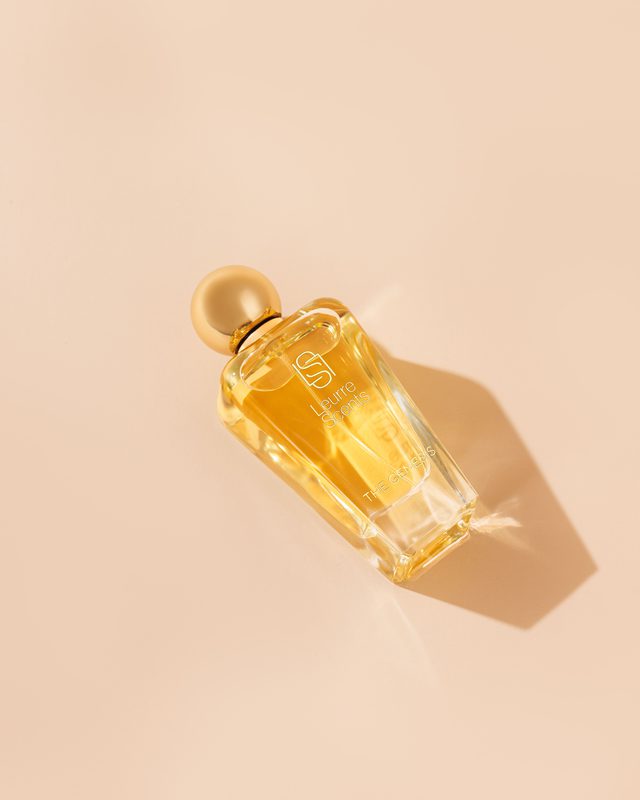 The Genesis bottle lying on its side in warm light