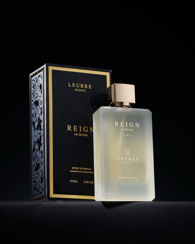 Reign bottle beside its black and gold box